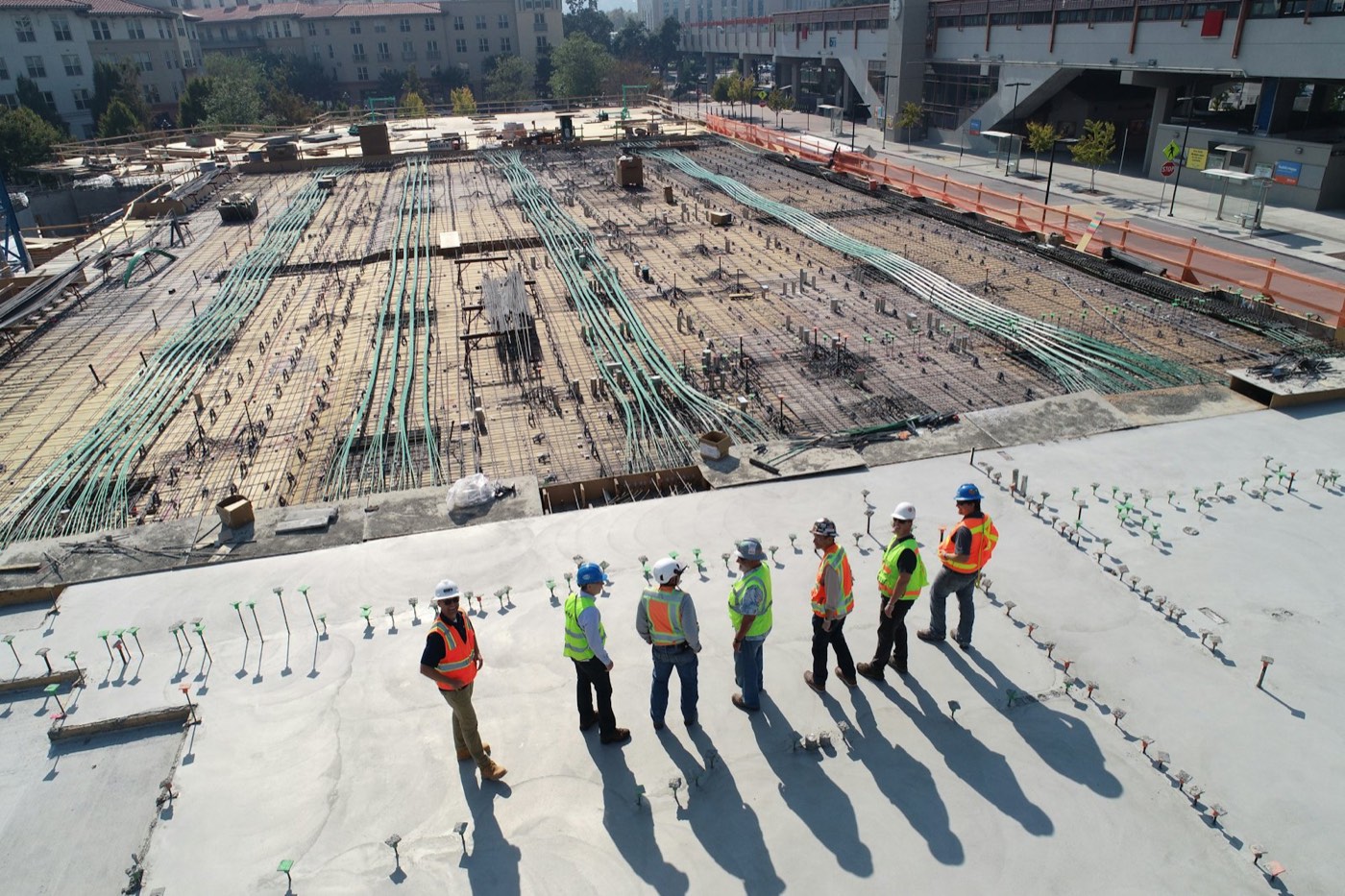 Site engineers reviewing a reinforced concrete slab on a Madwin construction site
